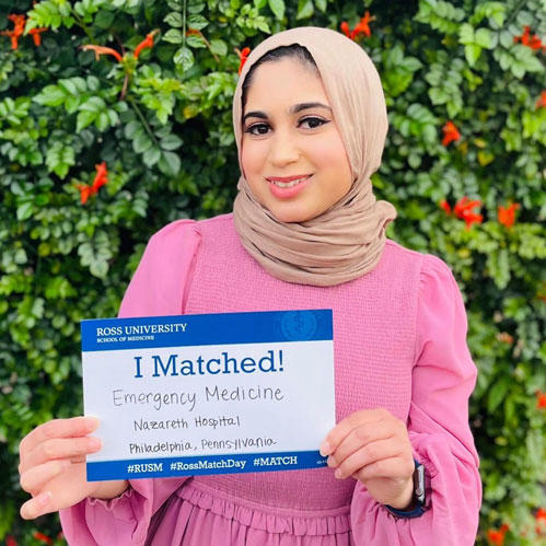 student holding match card