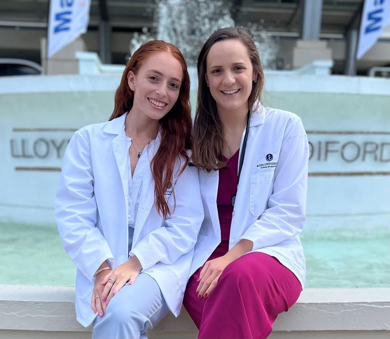two students in white coats