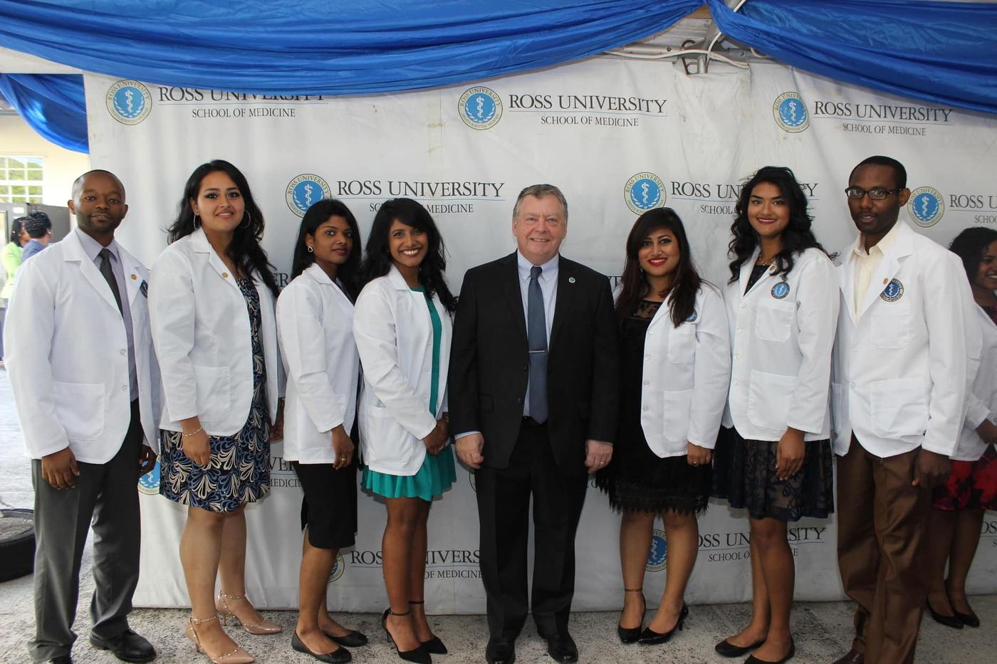 The Dean with students and their new white coats