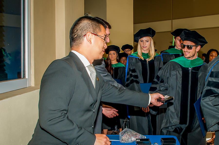 Man handing small gift to graduate