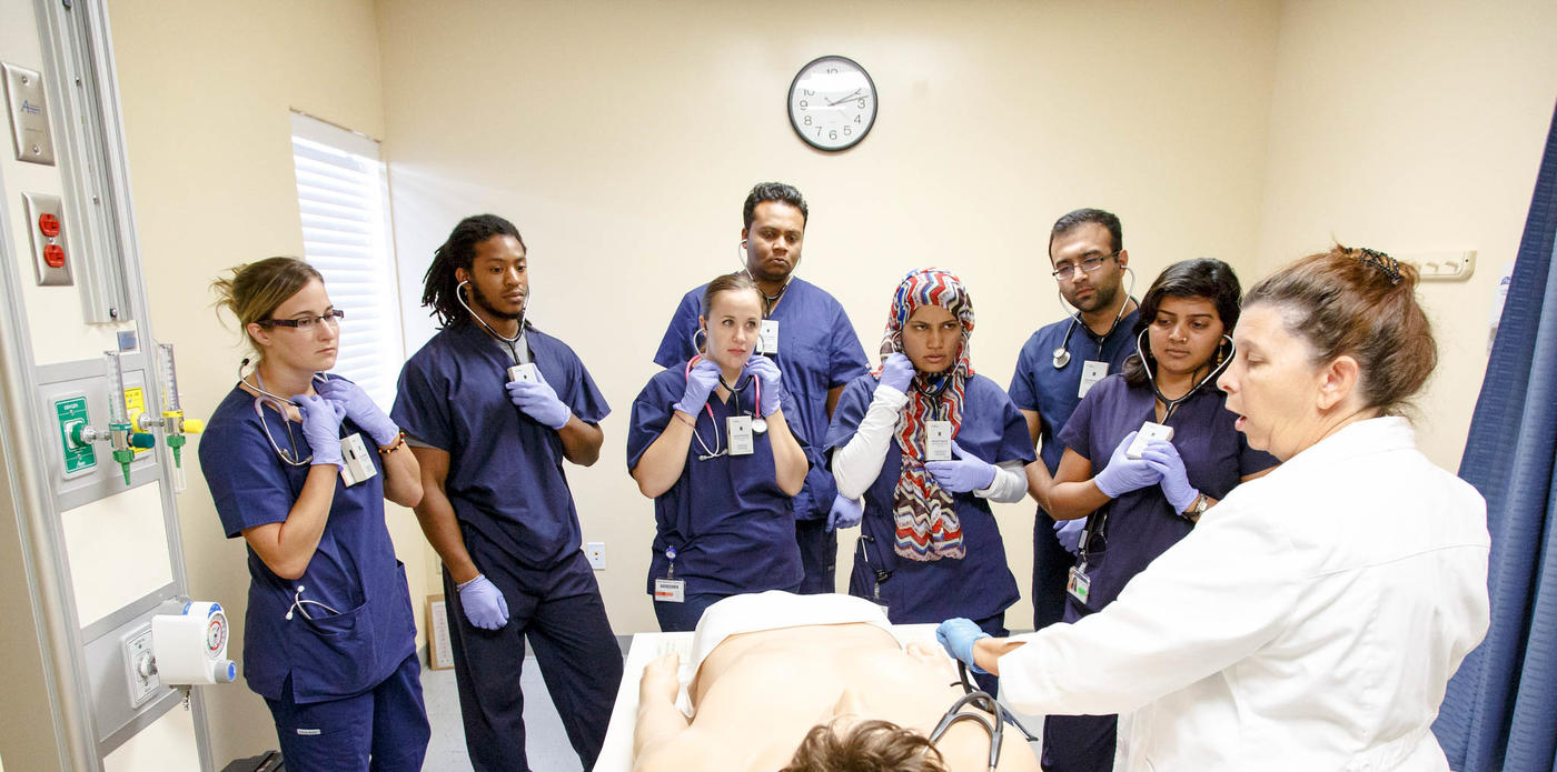 Students learning in patient room